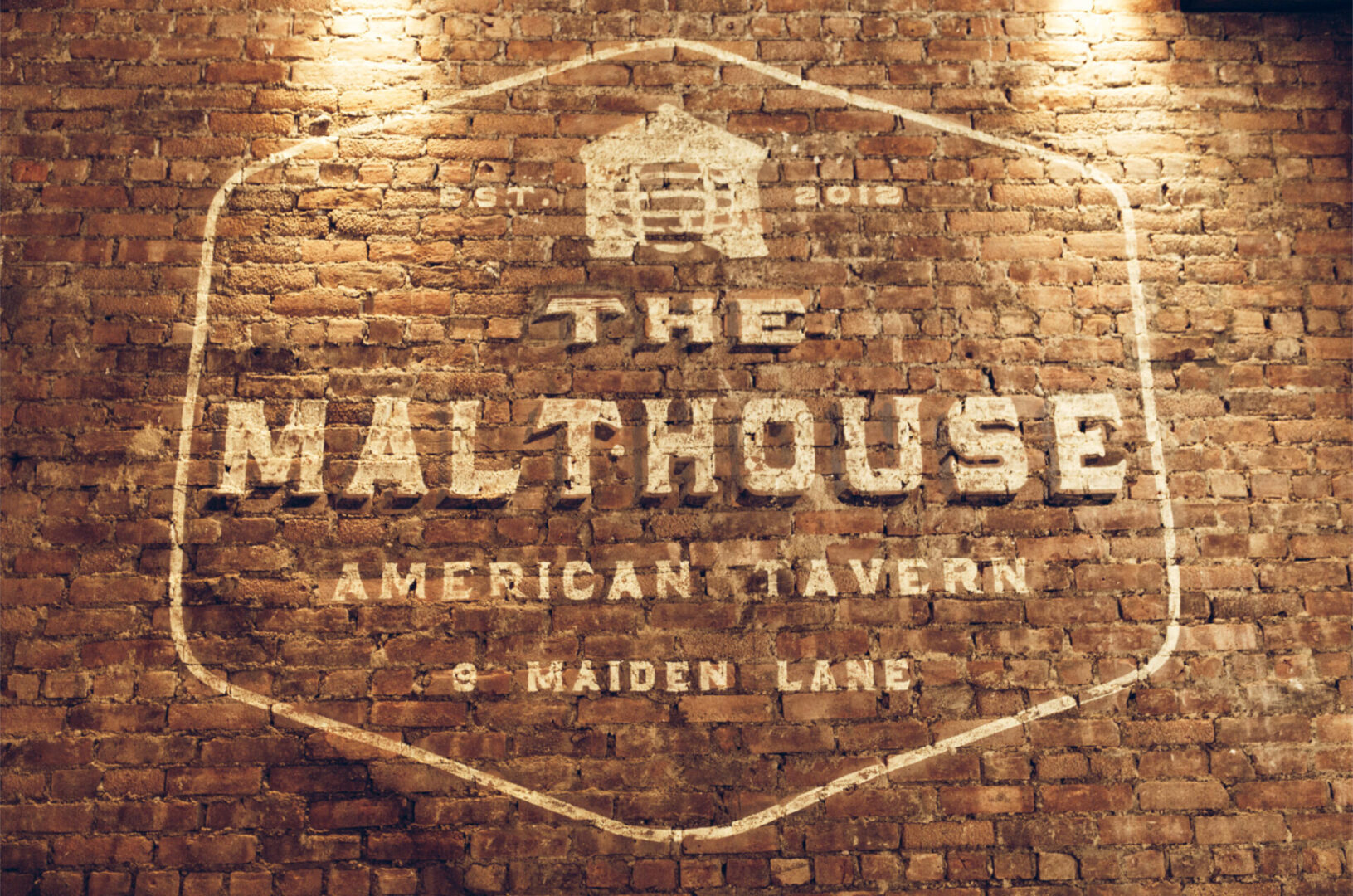 The Malthouse sign painted on a brick wall